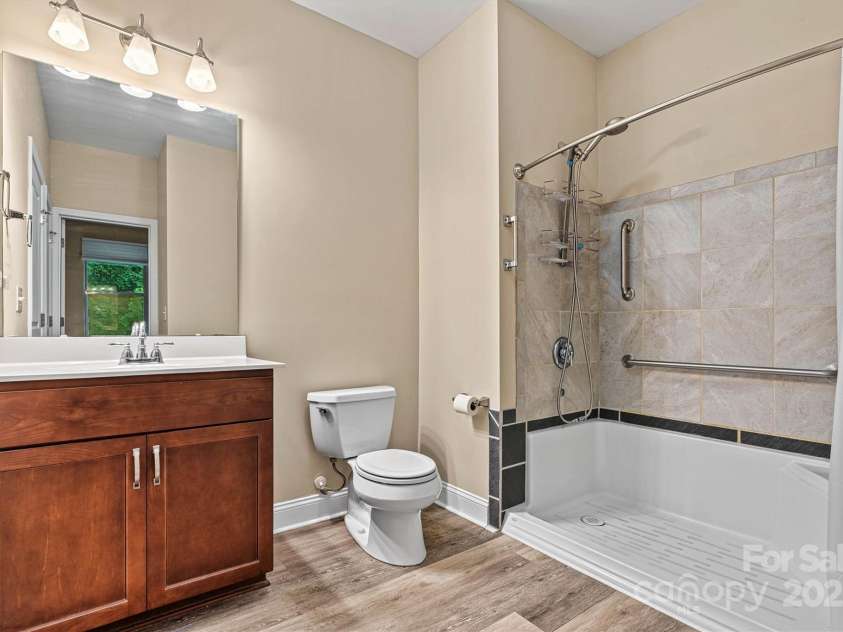 7020 Cedar Ridge Court, Mount Holly, NC 28120.  MLS# CAR4256213, YatesRealty ID 16957. Hall bath is accessible from Living Area and from 3rd bedroom.  2nd bedroom is next door, allowing everyone easy access to the facilities.  Nice large space with a walk in shower.