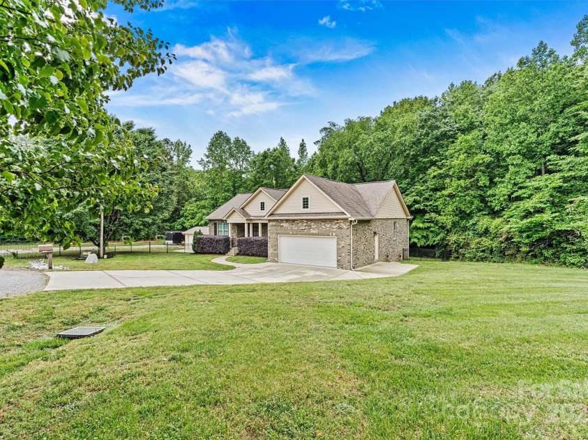7020 Cedar Ridge Court, Mount Holly, NC 28120.  MLS# CAR4256213, YatesRealty ID 16957. House sits at end of cul-de-sac, in a quiet rural neighborhood with no active HOA! Rear yard fencing could be extended further out, if desired.