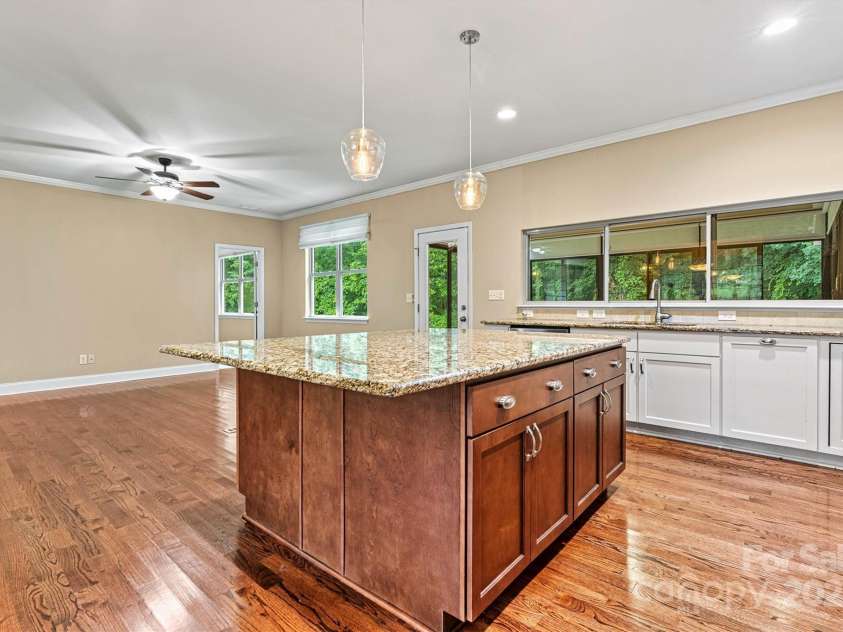 7020 Cedar Ridge Court, Mount Holly, NC 28120.  MLS# CAR4256213, YatesRealty ID 16957. Kitchen and Living Area spill out into the Sunroom effortlessly, making this layout especially nice for entertaining!