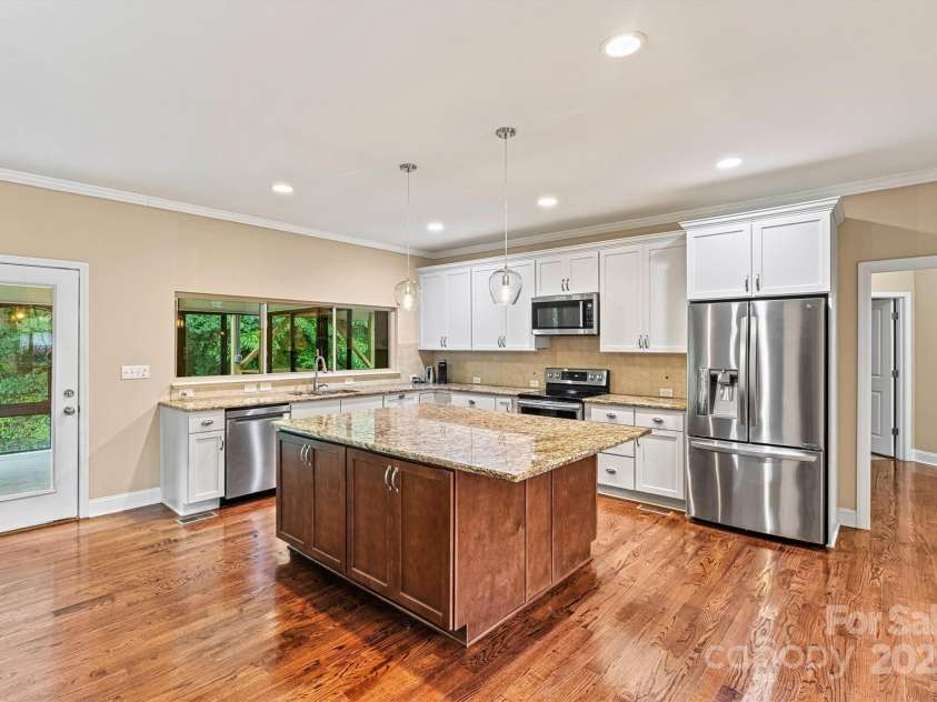 7020 Cedar Ridge Court, Mount Holly, NC 28120.  MLS# CAR4256213, YatesRealty ID 16957. Kitchen is very spacious! Plenty of cabinetry, with a 5'x7' eat at island.  All appliances remain, including the refigerator!