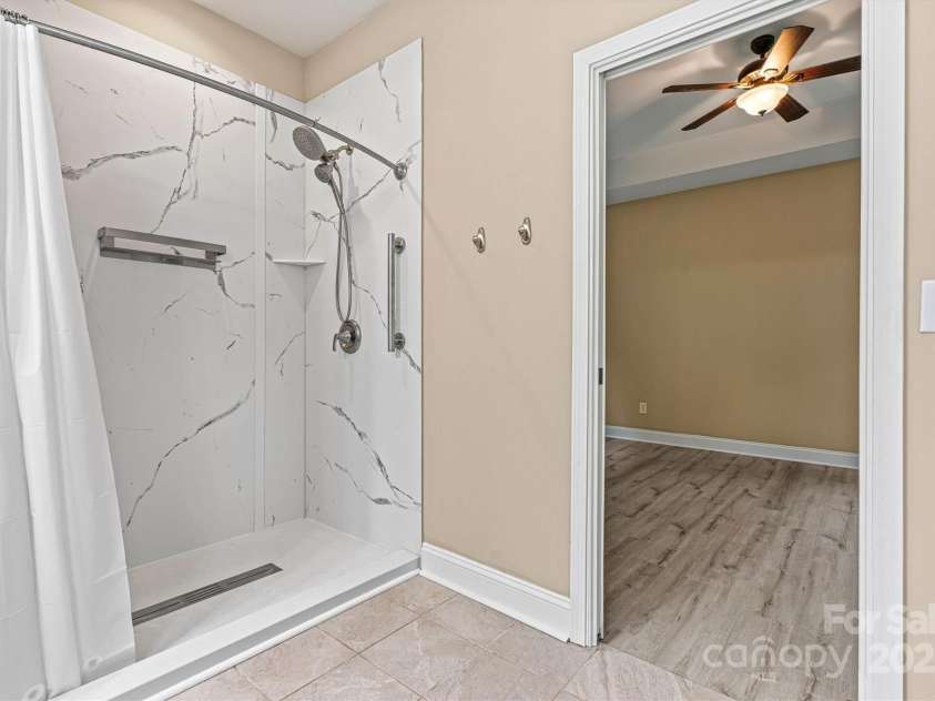 7020 Cedar Ridge Court, Mount Holly, NC 28120.  MLS# CAR4256213, YatesRealty ID 16957. No one will be cramped for space in this huge shower!  Primary bath is quite spacious.