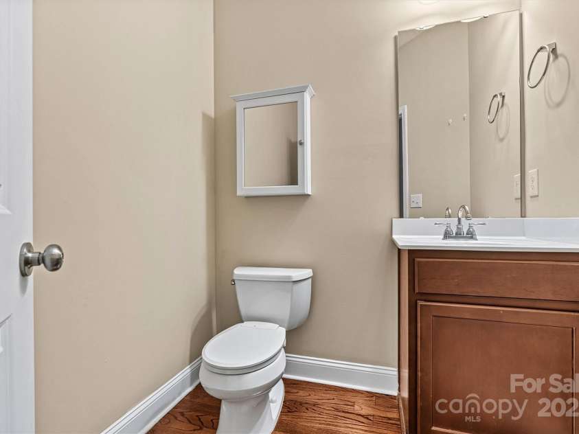 7020 Cedar Ridge Court, Mount Holly, NC 28120.  MLS# CAR4256213, YatesRealty ID 16957. Powder Room is located in the Mudroom, just behind the Kitchen.