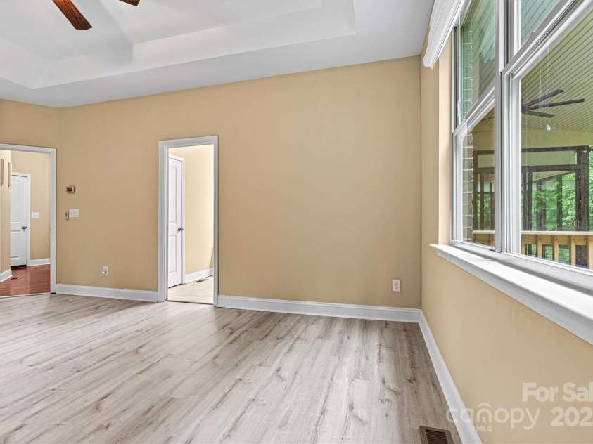 7020 Cedar Ridge Court, Mount Holly, NC 28120.  MLS# CAR4256213, YatesRealty ID 16957. Primary bedroom is privately located behind garage. and windows overlook the woods behind the home.