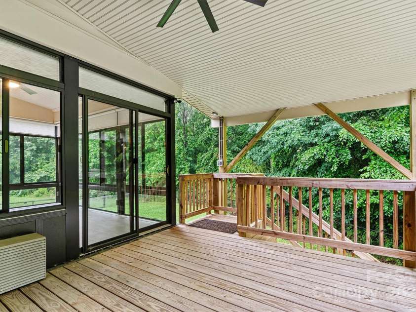 7020 Cedar Ridge Court, Mount Holly, NC 28120.  MLS# CAR4256213, YatesRealty ID 16957. Rear covered deck is adjacent to the Sunroom.  Steps lead down onto a concrete patio area.