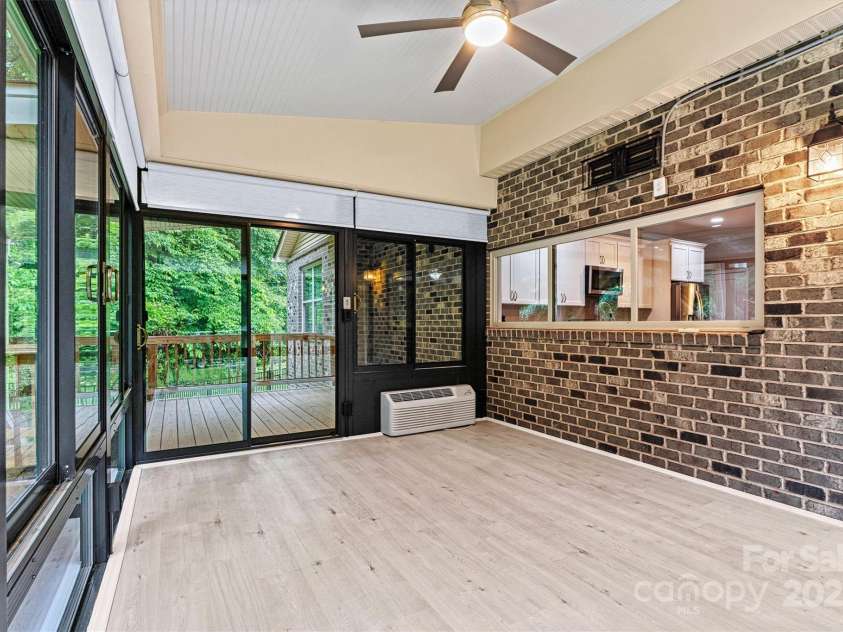 7020 Cedar Ridge Court, Mount Holly, NC 28120.  MLS# CAR4256213, YatesRealty ID 16957. Sunroom is located just off the Kitchen and Living Area of the home.  Great place for entertaining, watching TV, relaxing, or just enjoying nature!