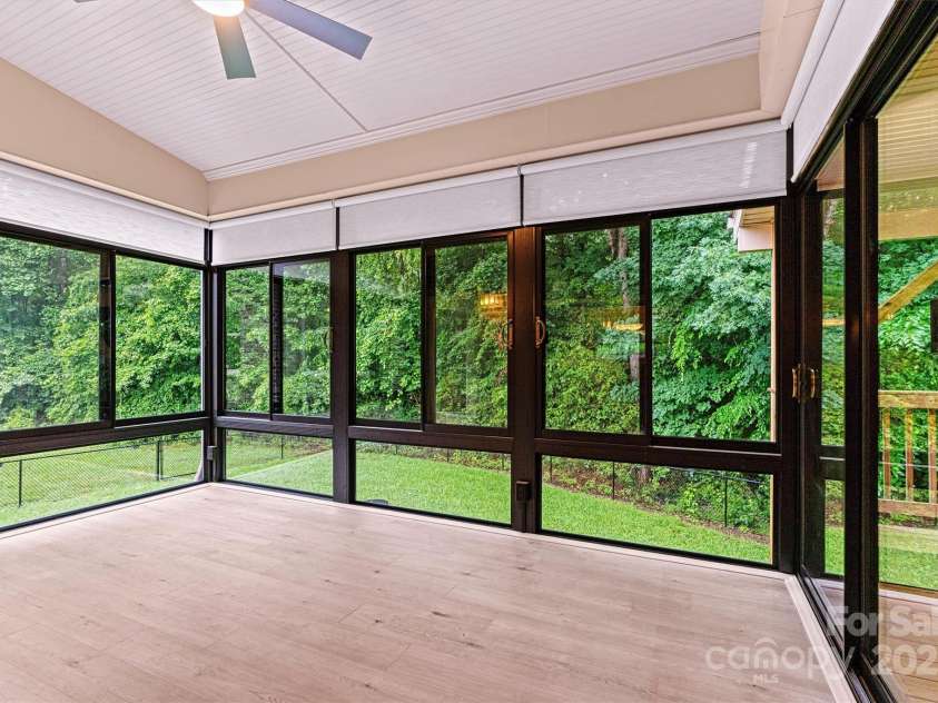 7020 Cedar Ridge Court, Mount Holly, NC 28120.  MLS# CAR4256213, YatesRealty ID 16957. Surrounded by woods and overlooking the fenced back yard, the Sunroom is the go to place in this home! Built in 2023, heated and cooled.