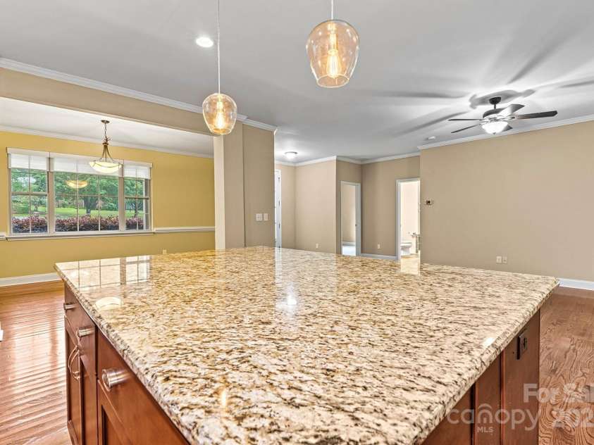 7020 Cedar Ridge Court, Mount Holly, NC 28120.  MLS# CAR4256213, YatesRealty ID 16957. This huge Granite topped Kitchen island is 5'x7'!  Plenty of room for meal prep, casual meals, or whatever activity you decide!  Formal Dining Room is across from the Kitchen.