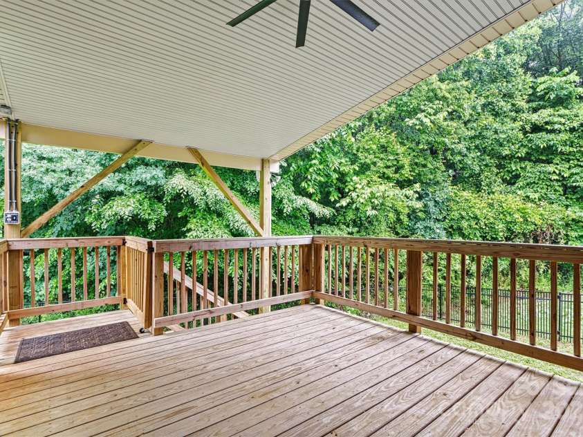 7020 Cedar Ridge Court, Mount Holly, NC 28120.  MLS# CAR4256213, YatesRealty ID 16957. This rear covered deck was added in 2024.  Protected from the hot sun and rain, this is a great spot!