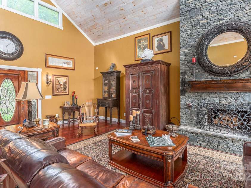 1706 Rock House Cove Road, Clyde, NC 28721.  MLS# CAR4263757, YatesRealty ID 16969. Beautiful woodburning stone fireplace