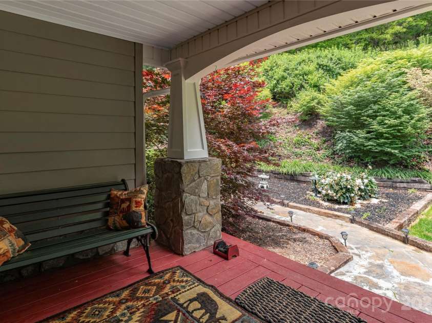 1706 Rock House Cove Road, Clyde, NC 28721.  MLS# CAR4263757, YatesRealty ID 16969. Covered front porch and stone walkway