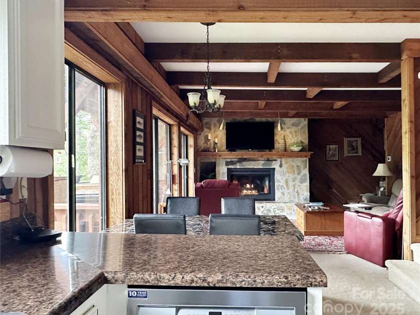 221 Toxaway Falls Drive, Lake Toxaway, NC 28747.  MLS# CAR4246910, YatesRealty ID 16979. From kitchen to fireplace