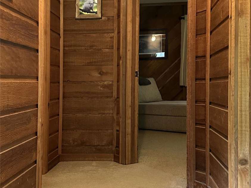 221 Toxaway Falls Drive, Lake Toxaway, NC 28747.  MLS# CAR4246910, YatesRealty ID 16979. Hallway to bedrooms