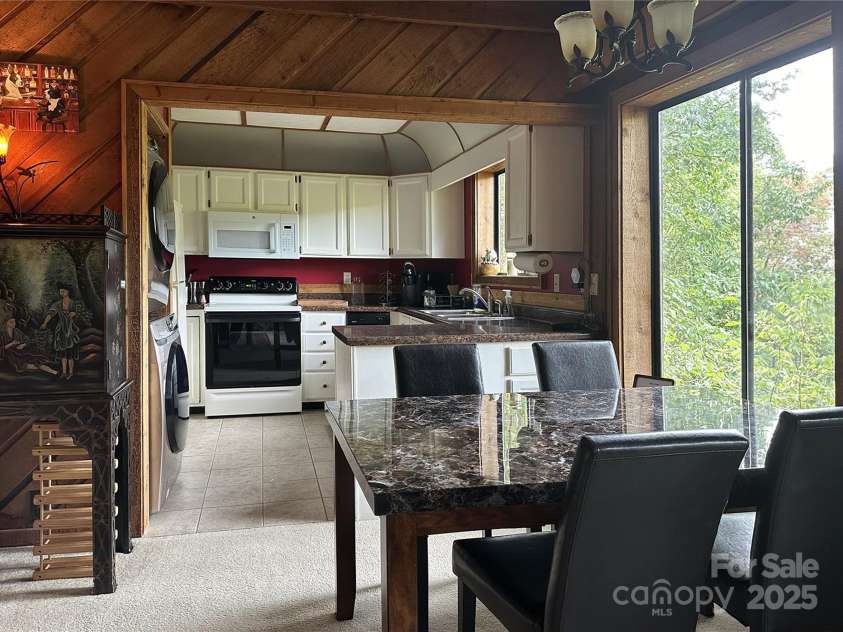 221 Toxaway Falls Drive, Lake Toxaway, NC 28747.  MLS# CAR4246910, YatesRealty ID 16979. To kitchen