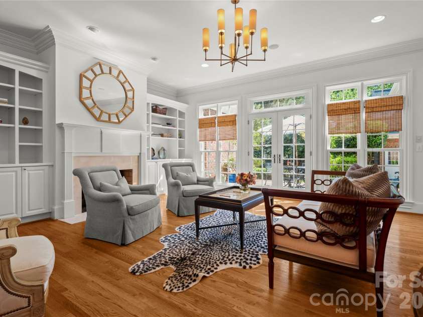 2046 Hopedale Avenue, Charlotte, NC 28207.  MLS# CAR4371805, YatesRealty ID 16992. Beautiful living room with windows and doors leading to the charming brick terrace