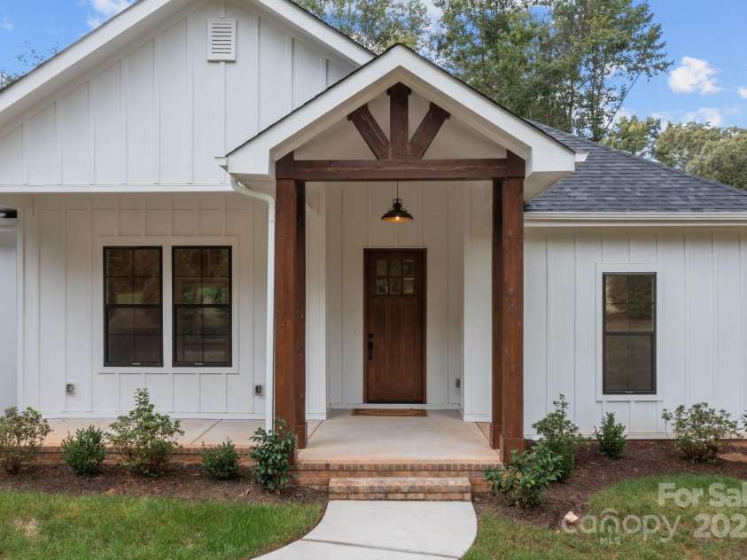 8225 Long Island Road, Catawba, NC 28609.  MLS# CAR4298824, YatesRealty ID 17010. Close-up view of the front exterior highlights the home's distinctive woodwork and architectural character.