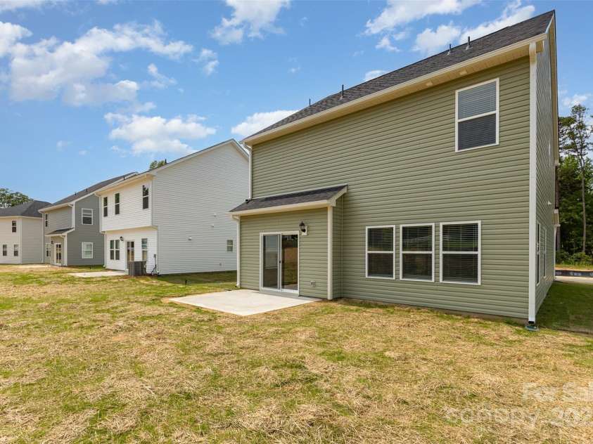 2043 Sadler Woods Lane, Charlotte, NC 28214.  MLS# CAR4265921, YatesRealty ID 17018. Back patio. Representative Photo