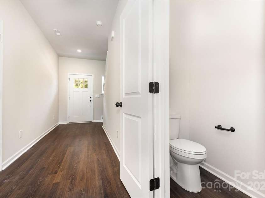 2051 Sadler Woods Lane, Charlotte, NC 28214.  MLS# CAR4265922, YatesRealty ID 17020. Half bathroom and hall. Representative Photo.