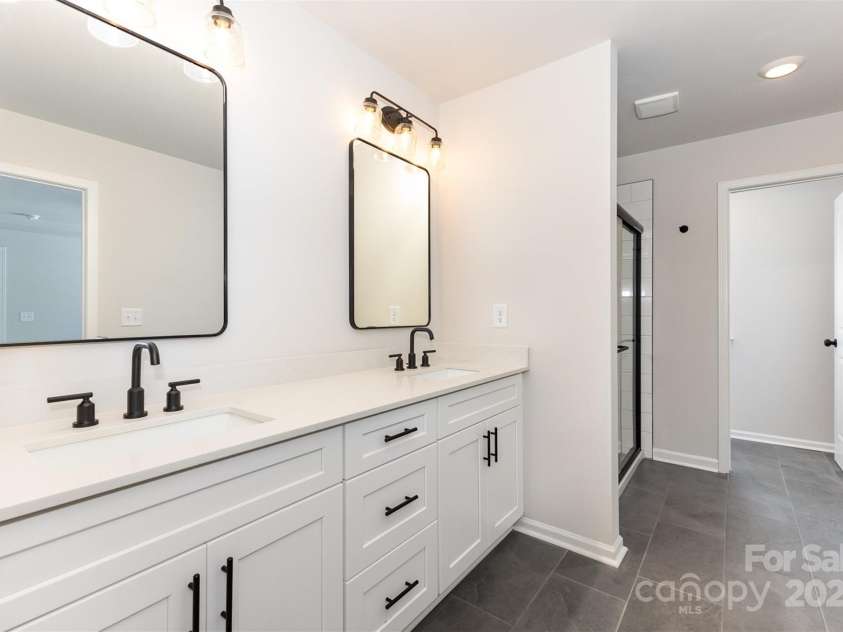 2051 Sadler Woods Lane, Charlotte, NC 28214.  MLS# CAR4265922, YatesRealty ID 17020. Primary bathroom. Representative Photo.