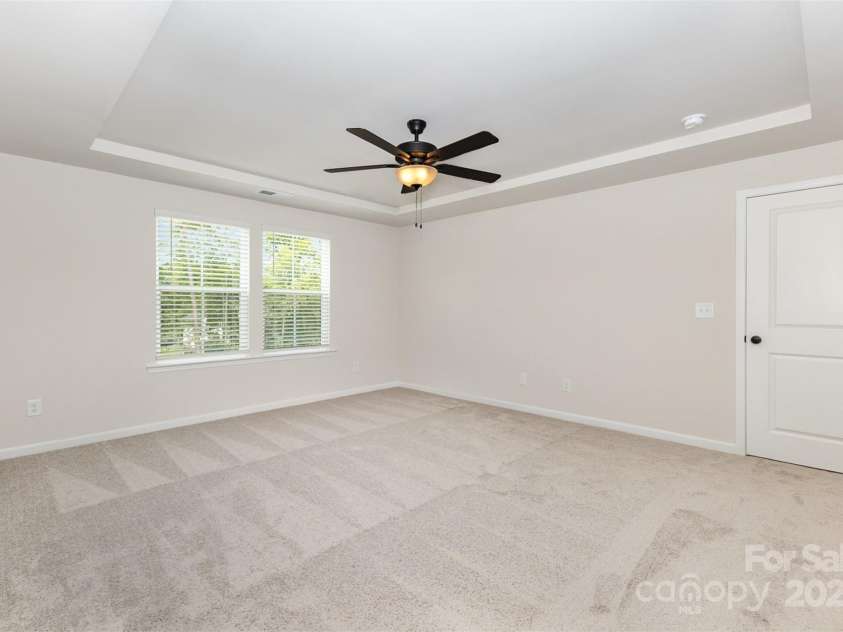 2051 Sadler Woods Lane, Charlotte, NC 28214.  MLS# CAR4265922, YatesRealty ID 17020. Primary bedroom w/ tray ceiling. Representative Photo.