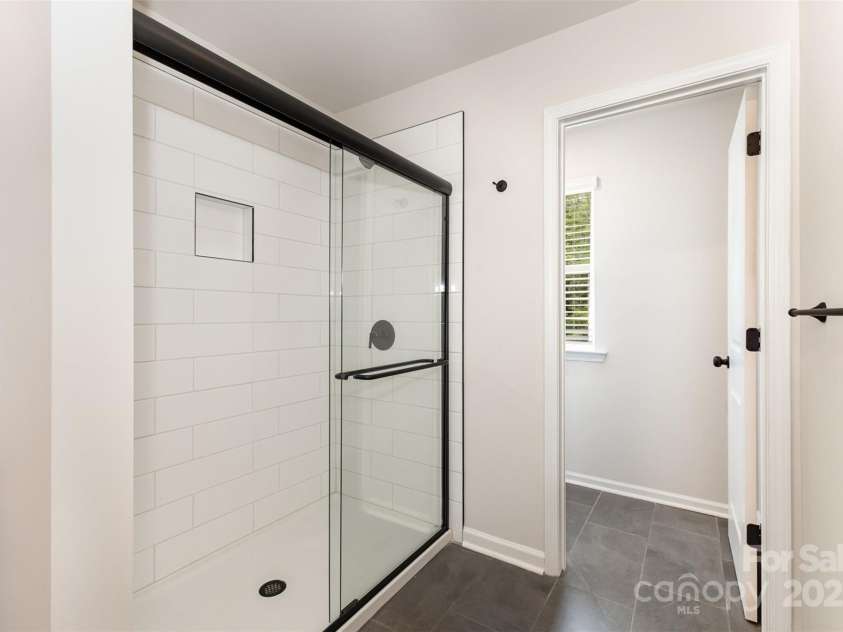 2051 Sadler Woods Lane, Charlotte, NC 28214.  MLS# CAR4265922, YatesRealty ID 17020. Tiled shower & floor. Representative Photo.