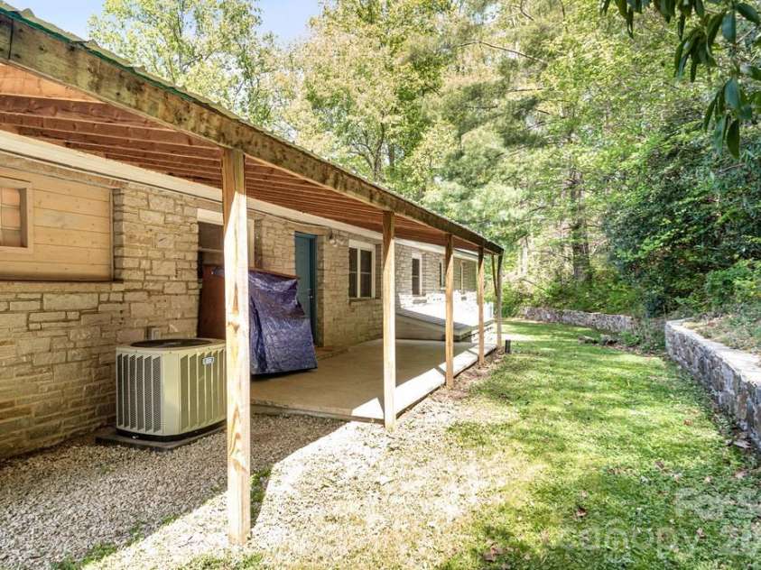 2629 Soco Road, Maggie Valley, NC 28751.  MLS# CAR4374834, YatesRealty ID 17029. Back patio and gorgeous stone wall