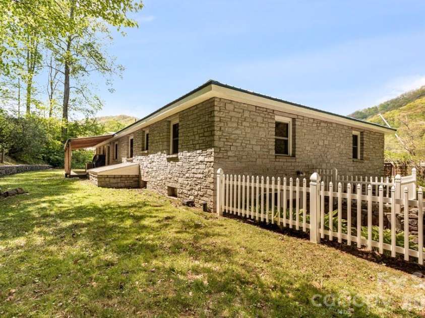 2629 Soco Road, Maggie Valley, NC 28751.  MLS# CAR4374834, YatesRealty ID 17029. Back yard and stone wall