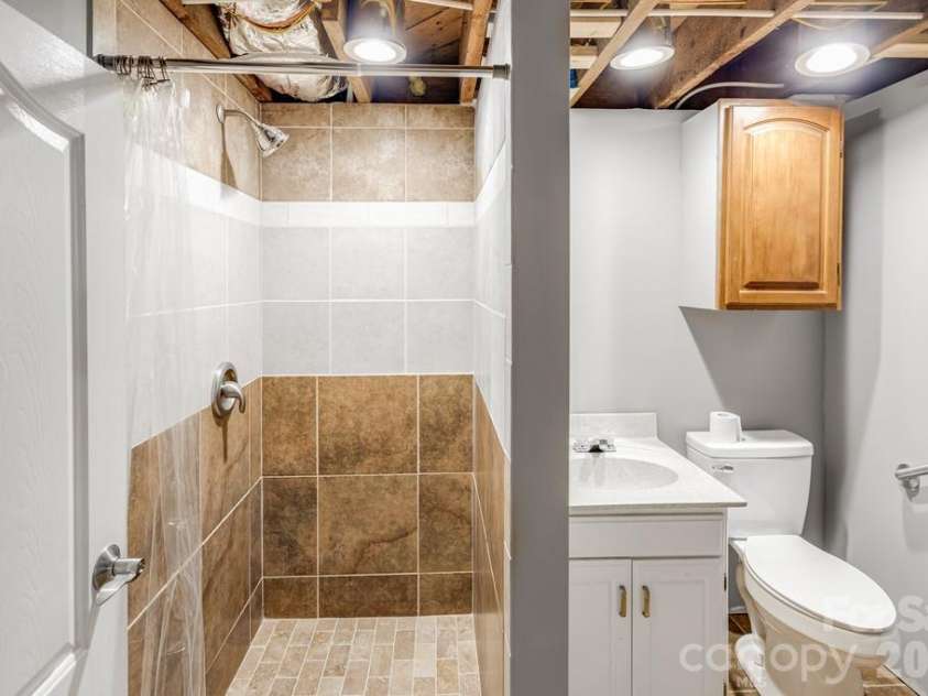 2629 Soco Road, Maggie Valley, NC 28751.  MLS# CAR4374834, YatesRealty ID 17029. Full bath with tiled shower in basement