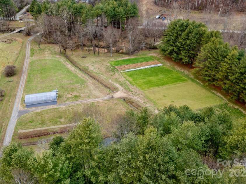9675 Montford Cove Road, Marion, NC 28752.  MLS# CAR4206983, YatesRealty ID 17032. Drone shot above house looking at the lower acreage.