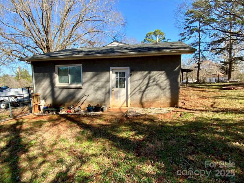 3807 Woodlawn Street, Sharon, SC 29742.  MLS# CAR4233211, YatesRealty ID 17047. Side of home showing garage door access