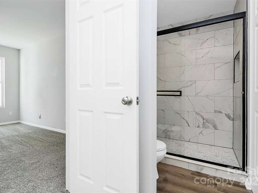 7214 Fox Point Drive, Charlotte, NC 28269.  MLS# CAR4266650, YatesRealty ID 17062. New tiled shower in primary bedroom