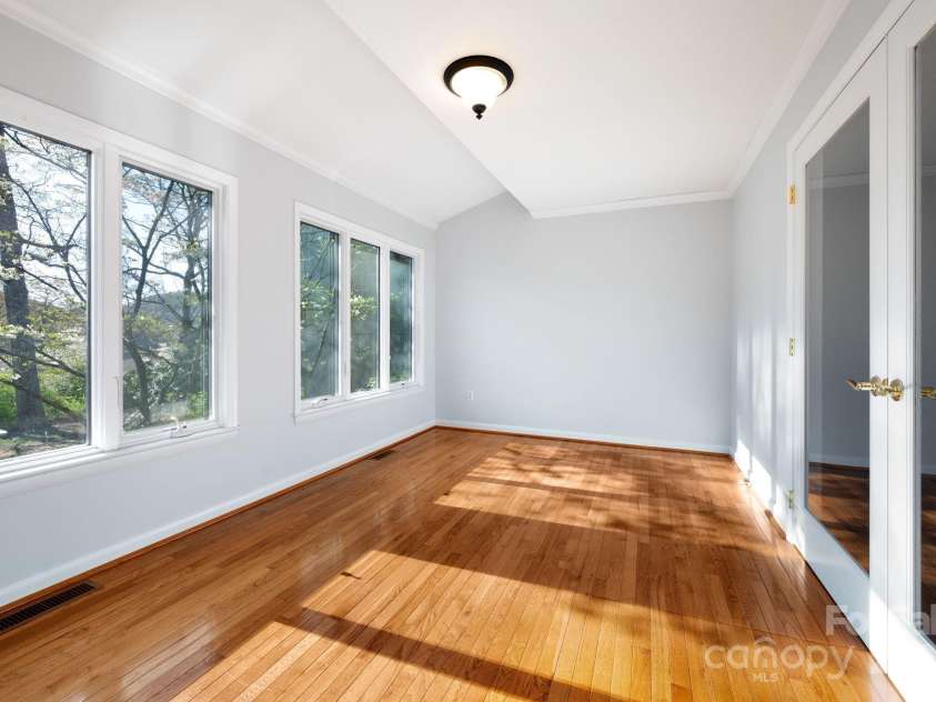 501 Crowfields Lane, Asheville, NC 28803.  MLS# CAR4246912, YatesRealty ID 17101. Hardwood Floors in Sunroom