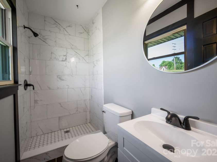 5704 Indian Trail Fairview Road, Indian Trail, NC 28079.  MLS# CAR4251613, YatesRealty ID 17110. Bathroom ensuite - fully renovated with tile shower & new vanity