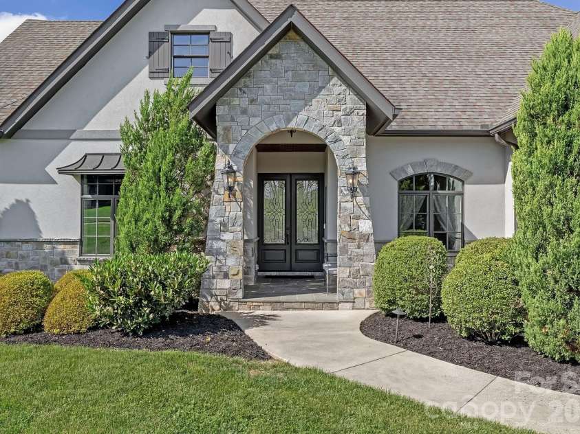 64 Water Hill Way, Fletcher, NC 28732.  MLS# CAR4369957, YatesRealty ID 17110. A Striking Stone Entry Sets the Tone