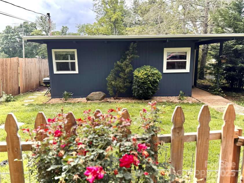 1 Fullam Drive, Arden, NC 28704.  MLS# CAR4263674, YatesRealty ID 17133. Front of home displaying Rose Garden