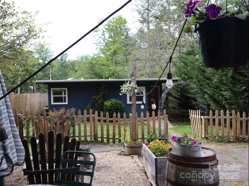 1 Fullam Drive, Arden, NC 28704.  MLS# CAR4263674, YatesRealty ID 17133. Outside sitting area looking at home