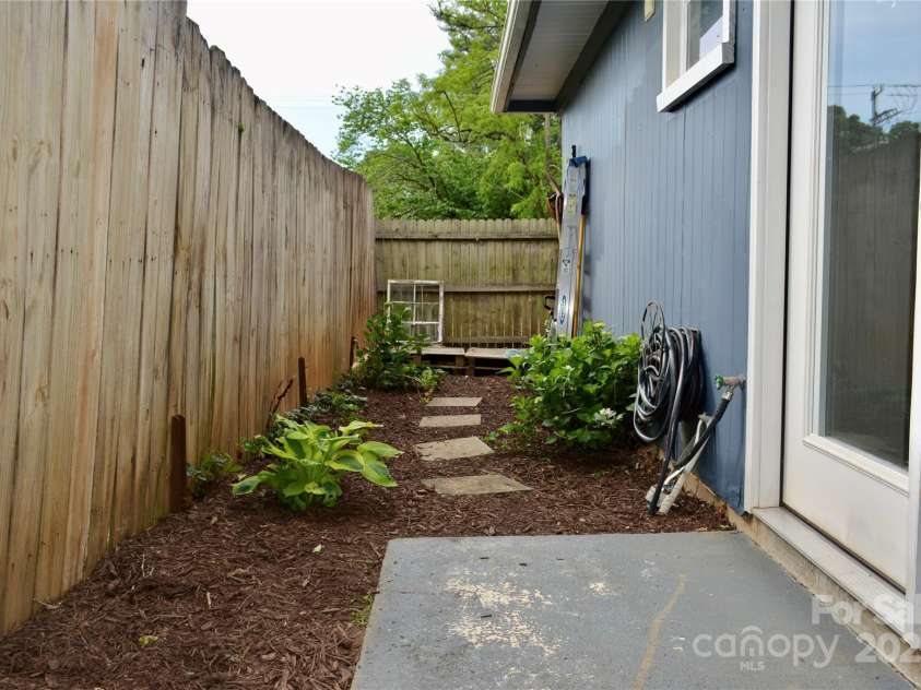 1 Fullam Drive, Arden, NC 28704.  MLS# CAR4263674, YatesRealty ID 17133. Side Entrance and patio