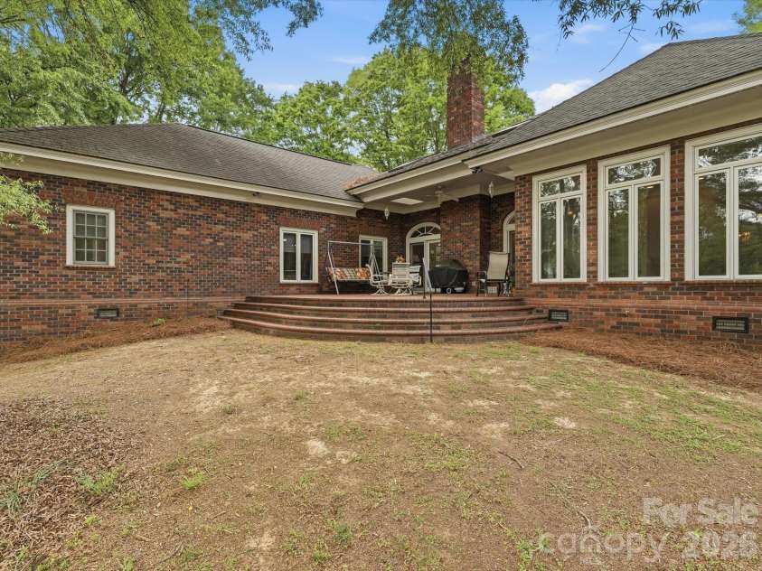 1215 Rosa Drive, Monroe, NC 28112.  MLS# CAR4366917, YatesRealty ID 17172. Curved brick patio facing lake