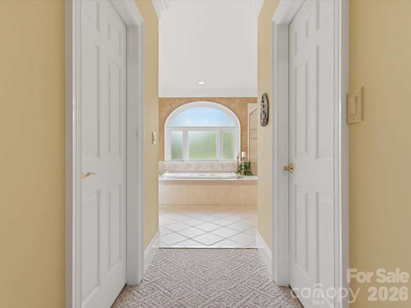 1215 Rosa Drive, Monroe, NC 28112.  MLS# CAR4366917, YatesRealty ID 17172. Primary bed to bath hallway with two spacious walk in closets