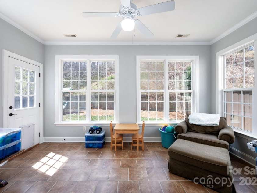11 Dansford Lane, Arden, NC 28704.  MLS# CAR4295929, YatesRealty ID 17185. Sunroom with Oversized Windows and Patio Access