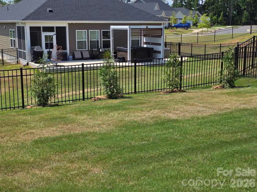2023 Merida Street, Charlotte, NC 28214.  MLS# CAR4306693, YatesRealty ID 17217. Backyard with tree line