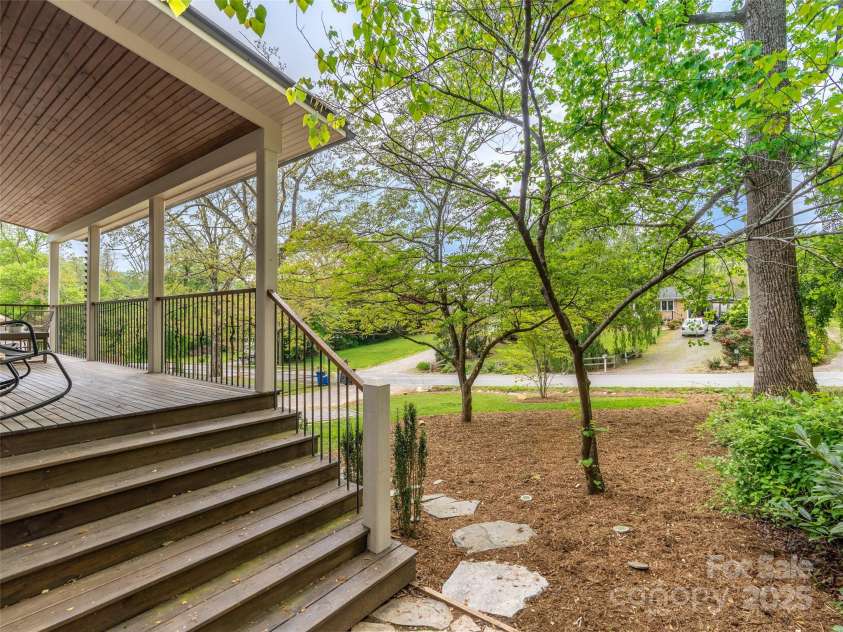 328 Mccoy Cove Road, Black Mountain, NC 28711.  MLS# CAR4248740, YatesRealty ID 17223. Big rocking chair covered front porch to sip coffee and take in the nature of the surroundings!