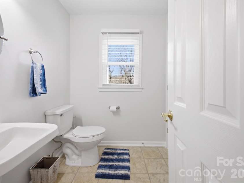 109 Elk Court, Mount Holly, NC 28120.  MLS# CAR4344317, YatesRealty ID 1724. Half-bath down stairs (Popcorn ceilings digitally removed to reflect pop-corn ceiling physically being removed in home)