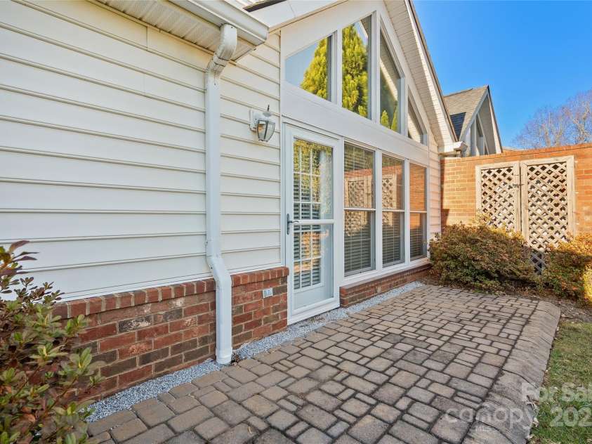 54 Lake Pointe Circle, Hendersonville, NC 28792.  MLS# CAR4323062, YatesRealty ID 1725. Private back patio off sunroom