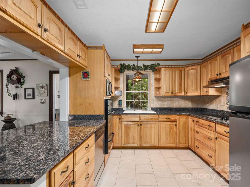 573 Valeria Lane, Pisgah Forest, NC 28768.  MLS# CAR4266219, YatesRealty ID 17256. Beautiful cabinetry and granite counters