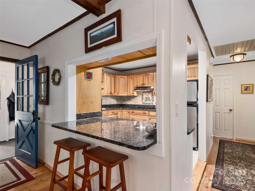 573 Valeria Lane, Pisgah Forest, NC 28768.  MLS# CAR4266219, YatesRealty ID 17256. Kitchen with breakfast bar and pass through
