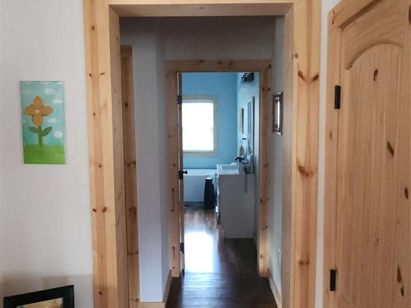 83 Kimberly Lane, Newland, NC 28657.  MLS# CAR4263748, YatesRealty ID 17257. Hallway looking into the main level full bath.