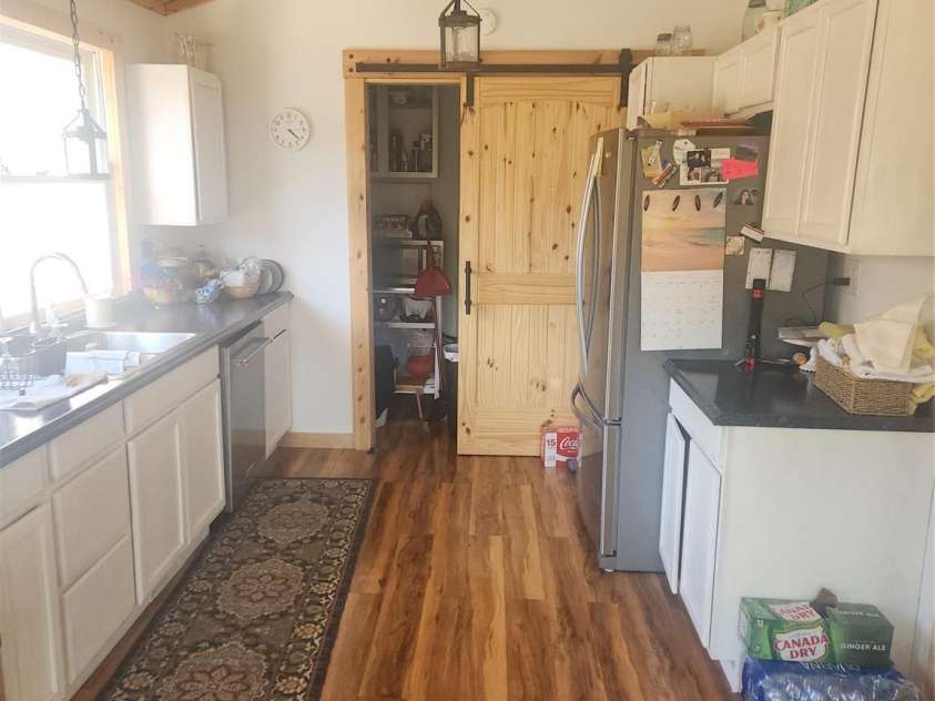 83 Kimberly Lane, Newland, NC 28657.  MLS# CAR4263748, YatesRealty ID 17257. Kitchen and view to pantry.