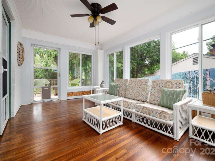 303 Country Club Road, Asheville, NC 28804.  MLS# CAR4310380, YatesRealty ID 17262. Heated Sunroom has heart pine floors and small balcony 