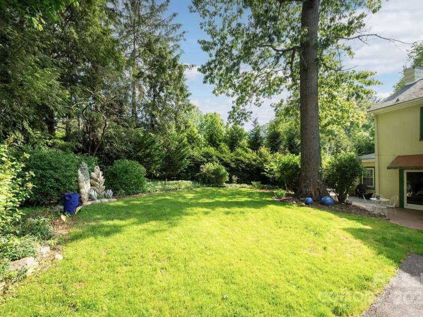 303 Country Club Road, Asheville, NC 28804.  MLS# CAR4310380, YatesRealty ID 17262. Private Sunny Backyard  with Established Gardens and Mature Trees