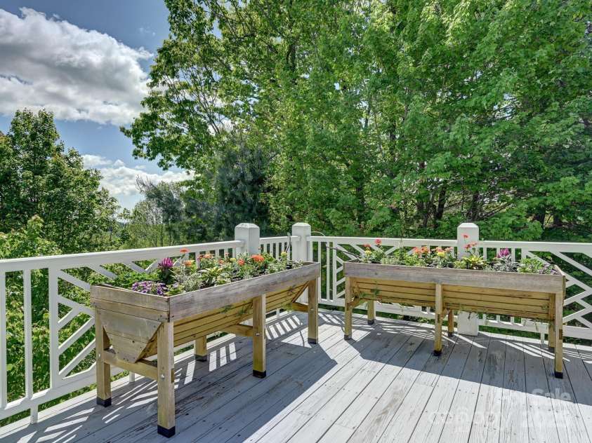 105 Spring Path, Hendersonville, NC 28739.  MLS# CAR4256171, YatesRealty ID 17277. Deck corner with garden growing troughs